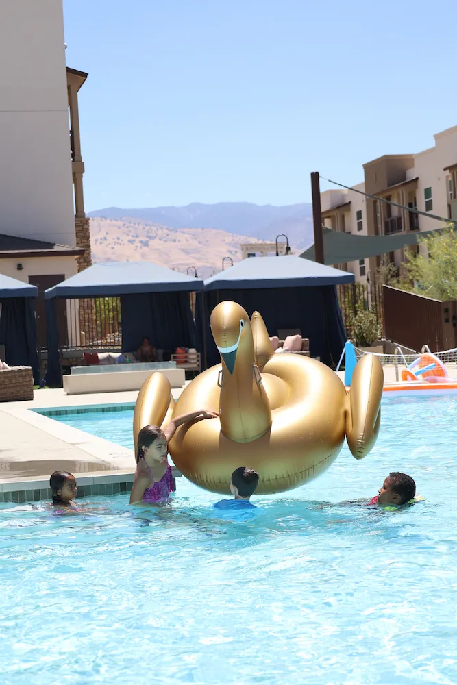 Kids in Pool Playing With Golden Inflatable - Terra Vista Community Event