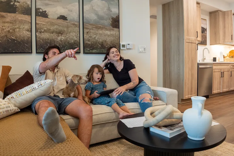Small Family Watching TV in Terra Vista Living Room