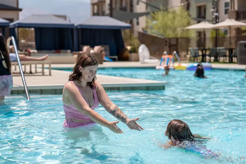 Mother Swimming With Young Daughter at Terra Vista