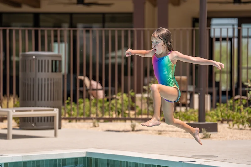 Young Girl Diving Into Pool